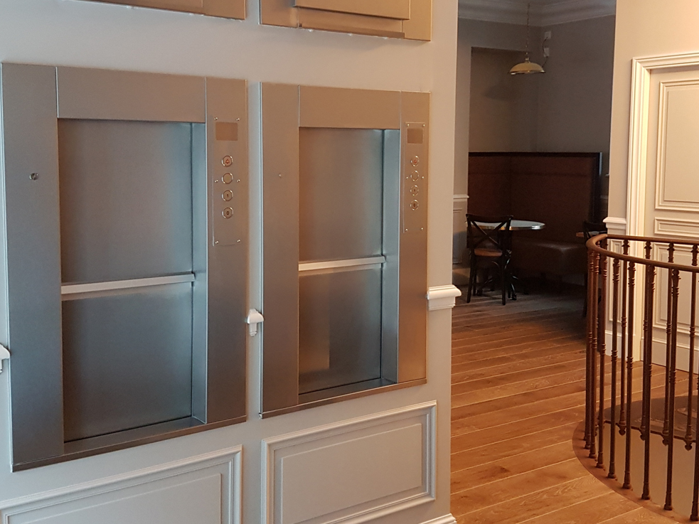 Pair of Stainless Steel Dumbwaiter Service Lifts within a restaurant