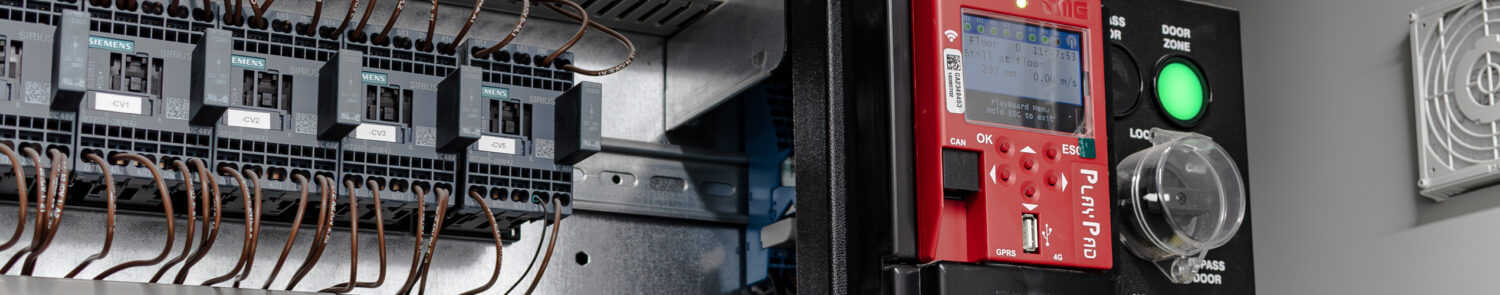 Close-up of electrical control panel featuring circuit breakers and a digital display unit.