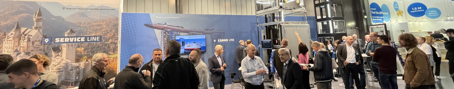 A busy exhibition space with attendees engaging and networking around display booths.