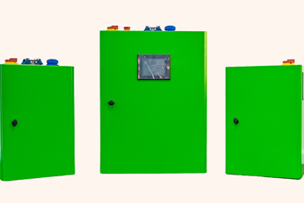 Three green electrical control cabinets with various knobs and a transparent window in the centre.