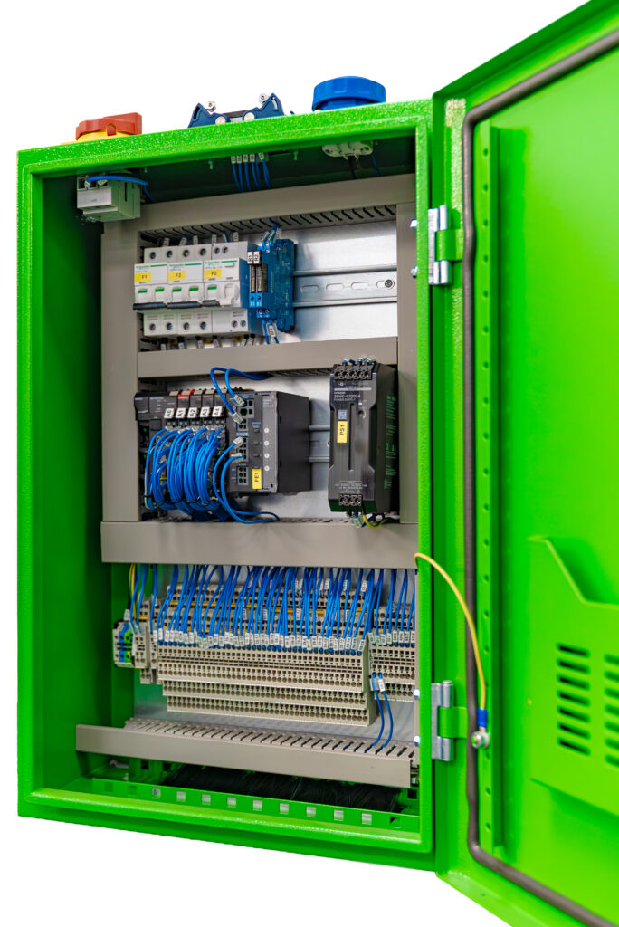 Open green electrical cabinet displaying various circuit components and wiring.