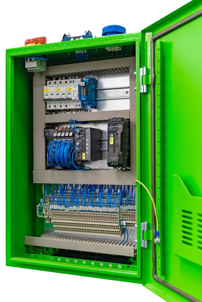Open green electrical cabinet displaying various circuit components and wiring.